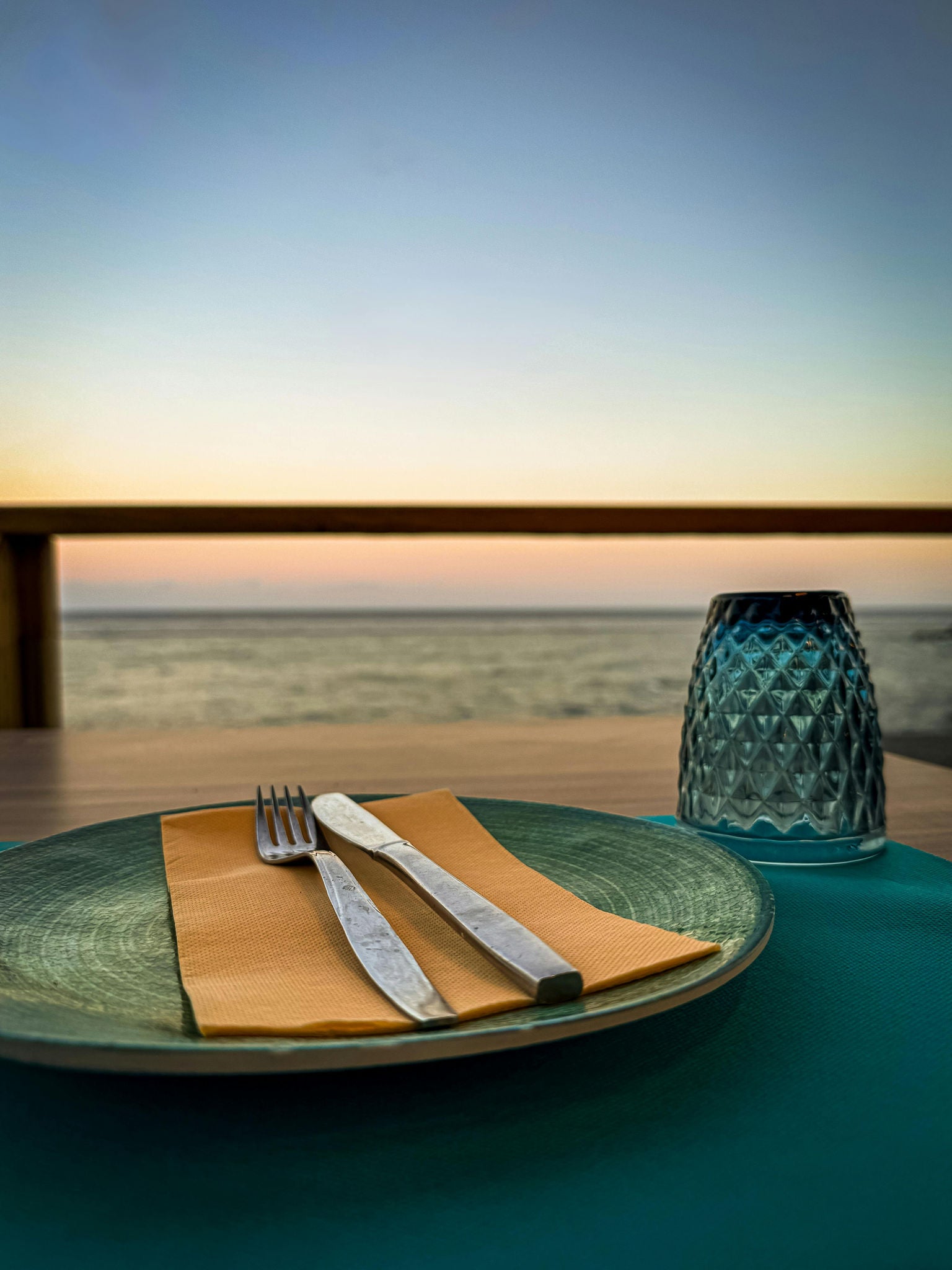 Elegant Seaside Dining Setup at Sunset
