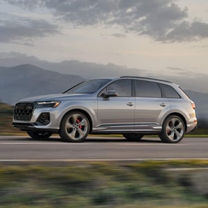 Side view of an Audi Q7 driving.