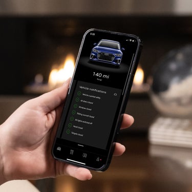  Hand holding a phone displaying the Vehicle Status Report.