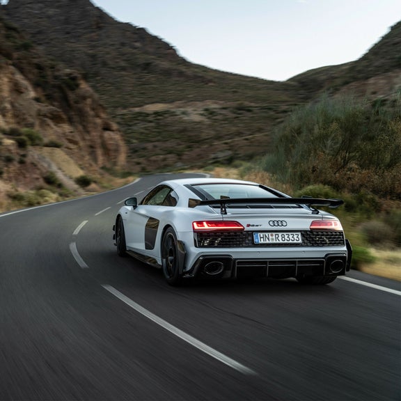 Three-quarter rear view of the Audi R8 GT accelerating.