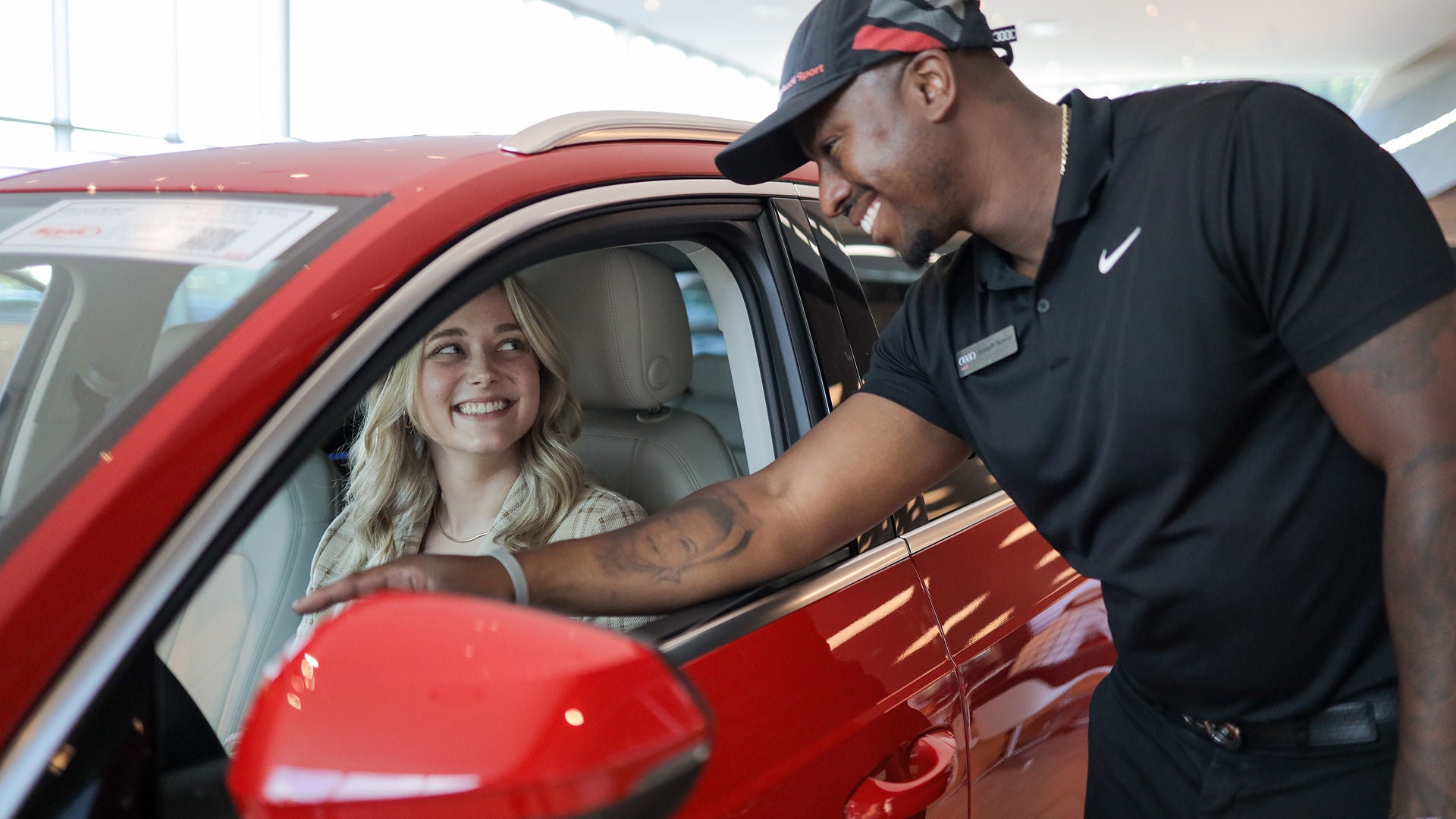 Audi Sale Specialist explaining vehicle features to a customer.