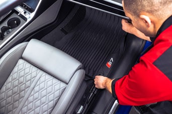 Technician installing floor mats