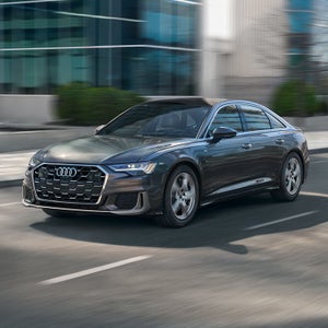 Left side of an Audi A6 driving.