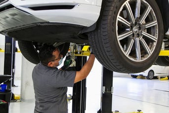 Service technician servicing vehicle.