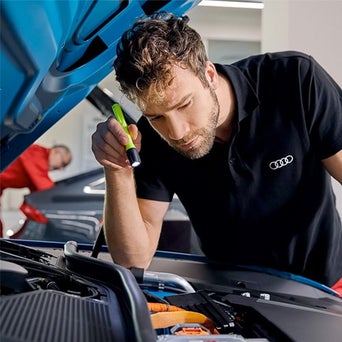 Service technician serving vehicle.