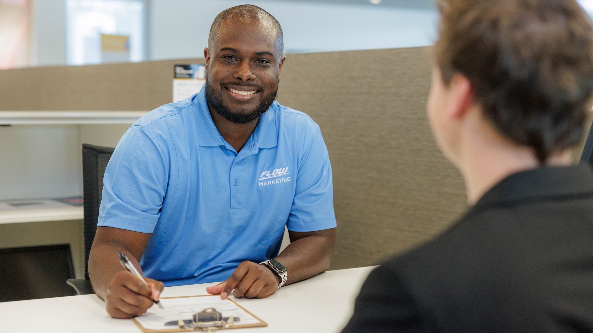 An Audi dealer explaining the features of an Audi vehicle to a customer.