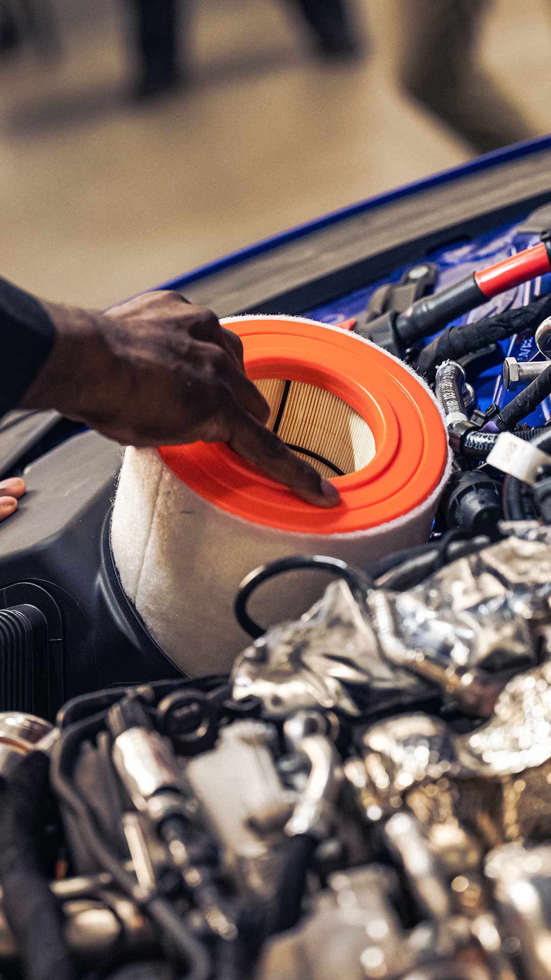 Audi service technician servicing a vehicle.