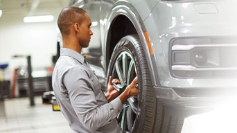 Audi Technician performing Tire Mount and Balance