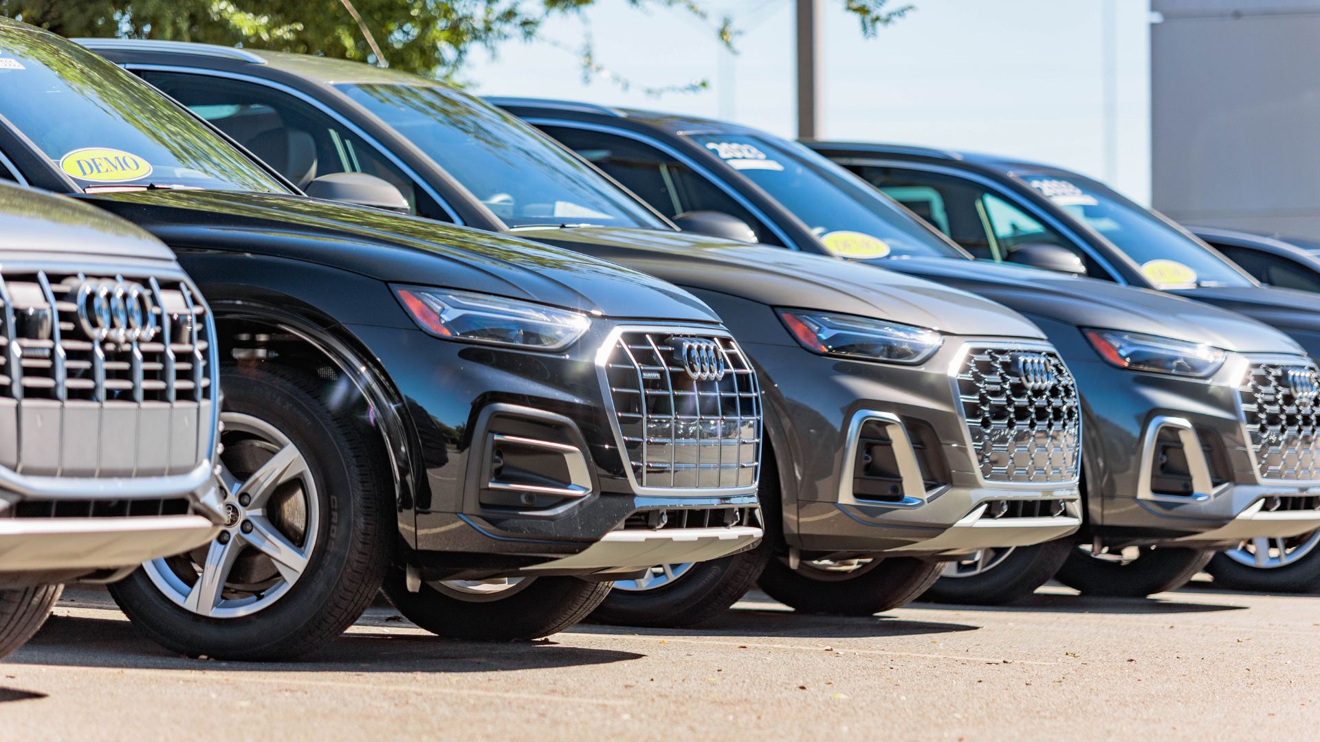 Lineup of Audi cars in the parking lot of Audi Greensboro