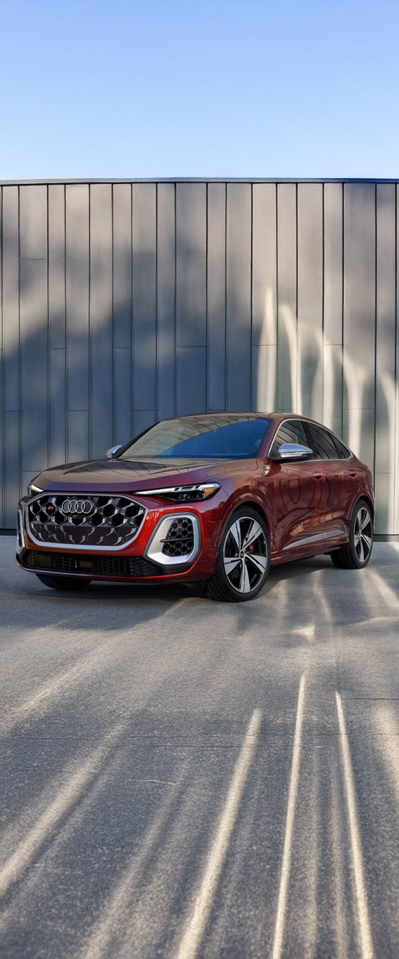 Exterior view of front and drivers side of red 2025 Audi Q5 configuration