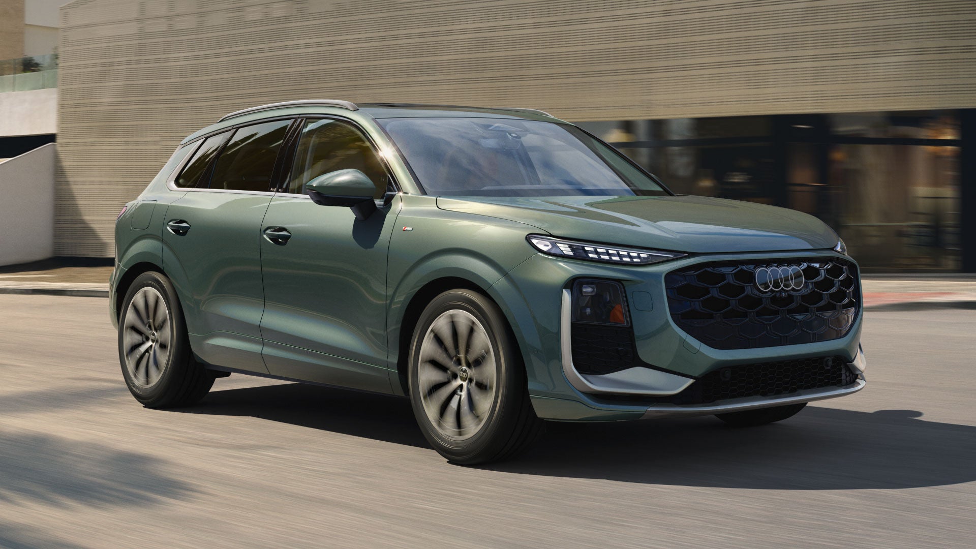 Green Q3 driving in the city.