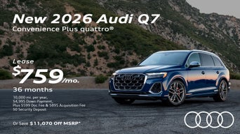 Side view of an Audi Q7 driving.