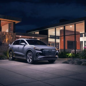 Audi Q4 e-tron parked at modern home — shop Q4 e-tron at Audi Sewickley near Pittsburgh