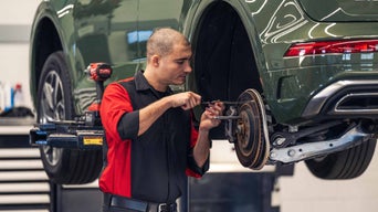Service technician servicing tire.