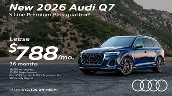 Side view of an Audi Q7 driving.