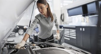 Service technician servicing vehicle.