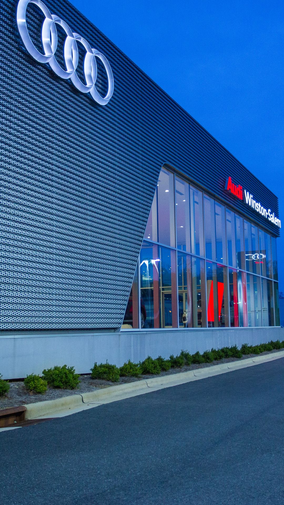 Audi Sale Specialist walking through the showroom with a couple.