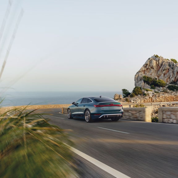 Three-quarter rear view of the Audi S6 e-tron accelerating.