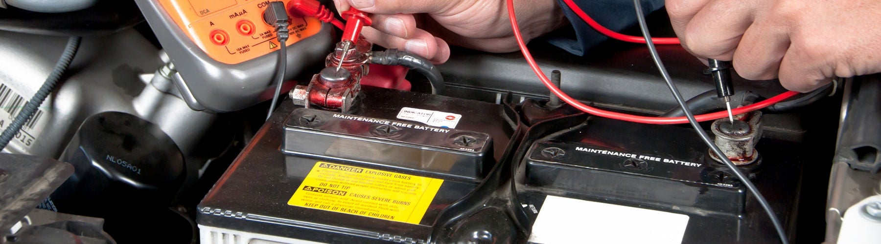 A technician installing an Audi car battery