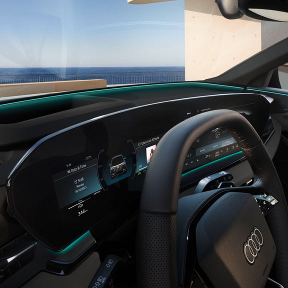 Close-up on the Audi virtual cockpit plus and steering wheel in the Audi Q6 e-tron, depicting the interaction light strip feature.