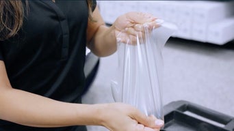 Technician demonstrating the durability of the paint protection film.