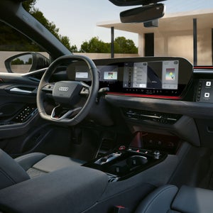 View of the interior cabin of the Audi S6 e-tron, showing the virtual cockpit and MMI display.