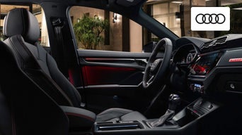 The interior cabin of the 2024 Audi Q3 features an advanced touchscreen display, leather seats, and ambient lighting. 