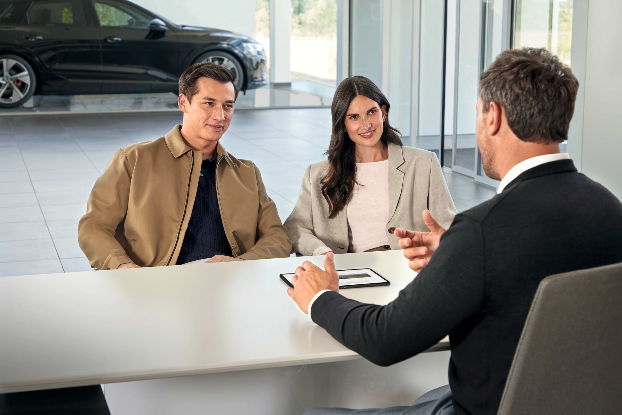 Image of a couple meeting with an Audi rep to return their lease