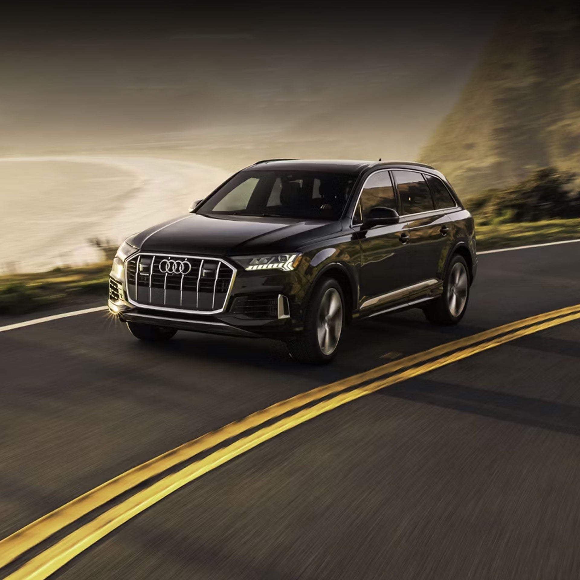 Three-quarter front view of the Audi Q7 accelerating.