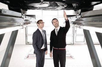 Service technician inspecting vehicle.