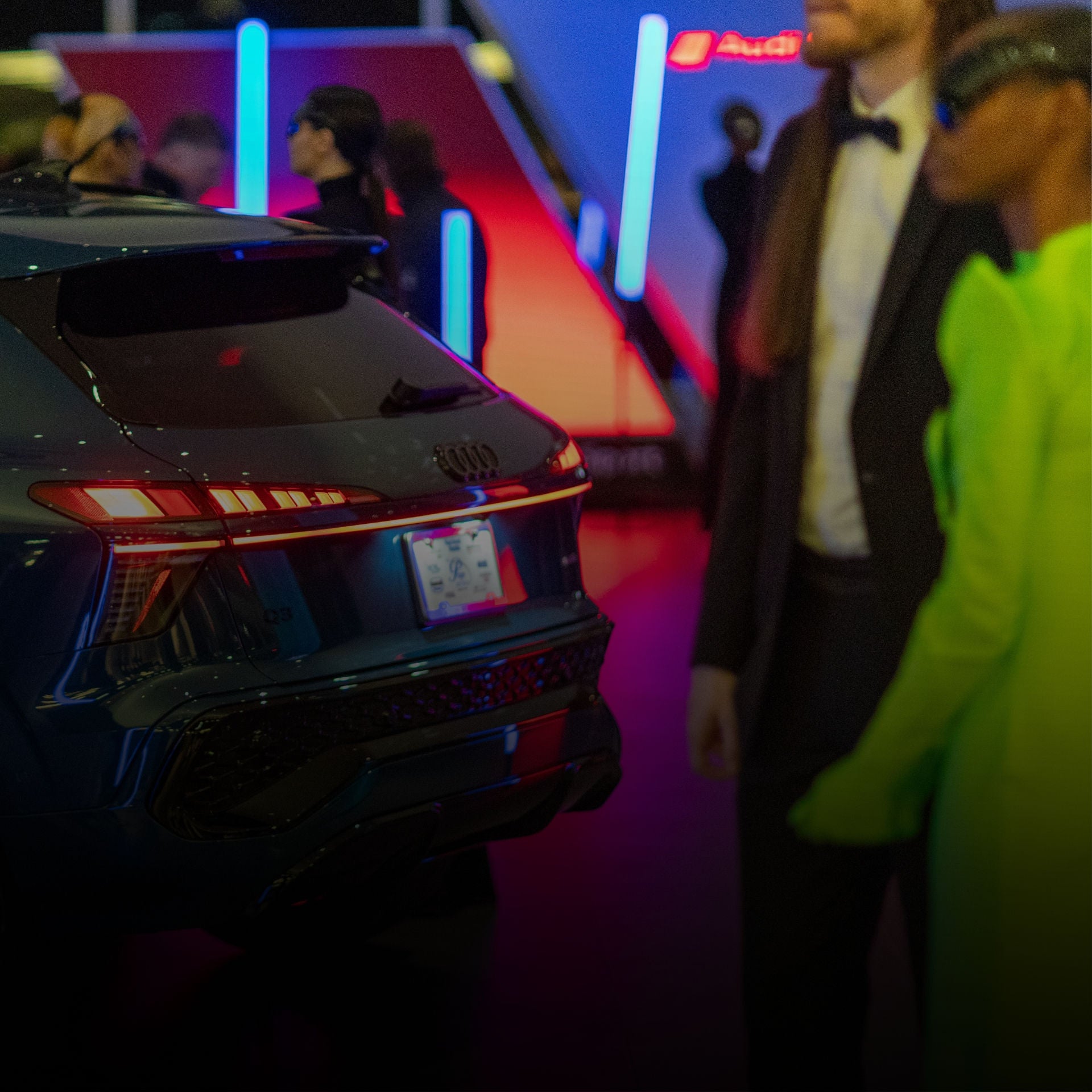 Side view of a white Audi SUV parked on the side of the street. 