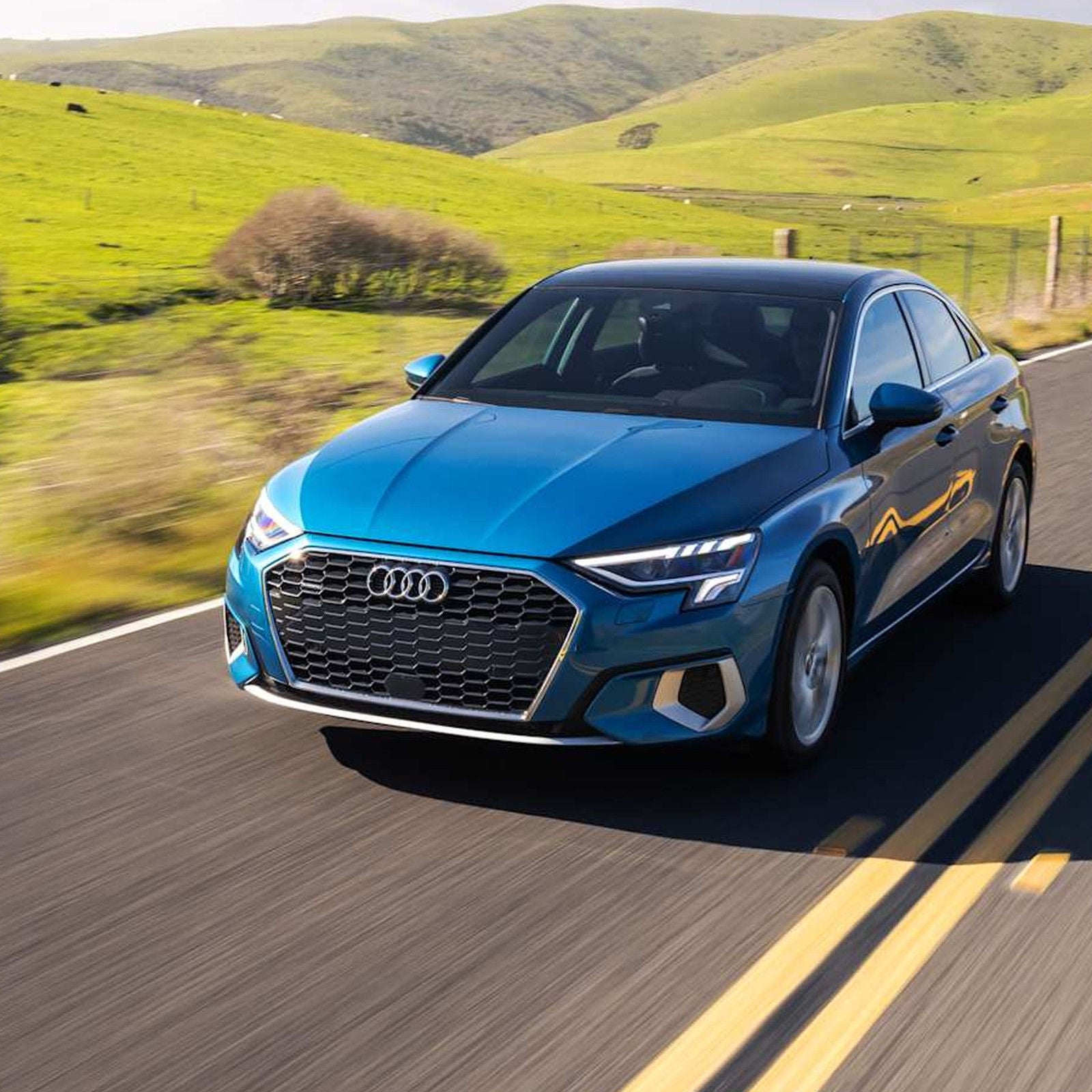 2026 Audi A3 sedan driving, Progressive Red.
