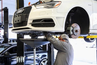 Service technician servicing vehicle.