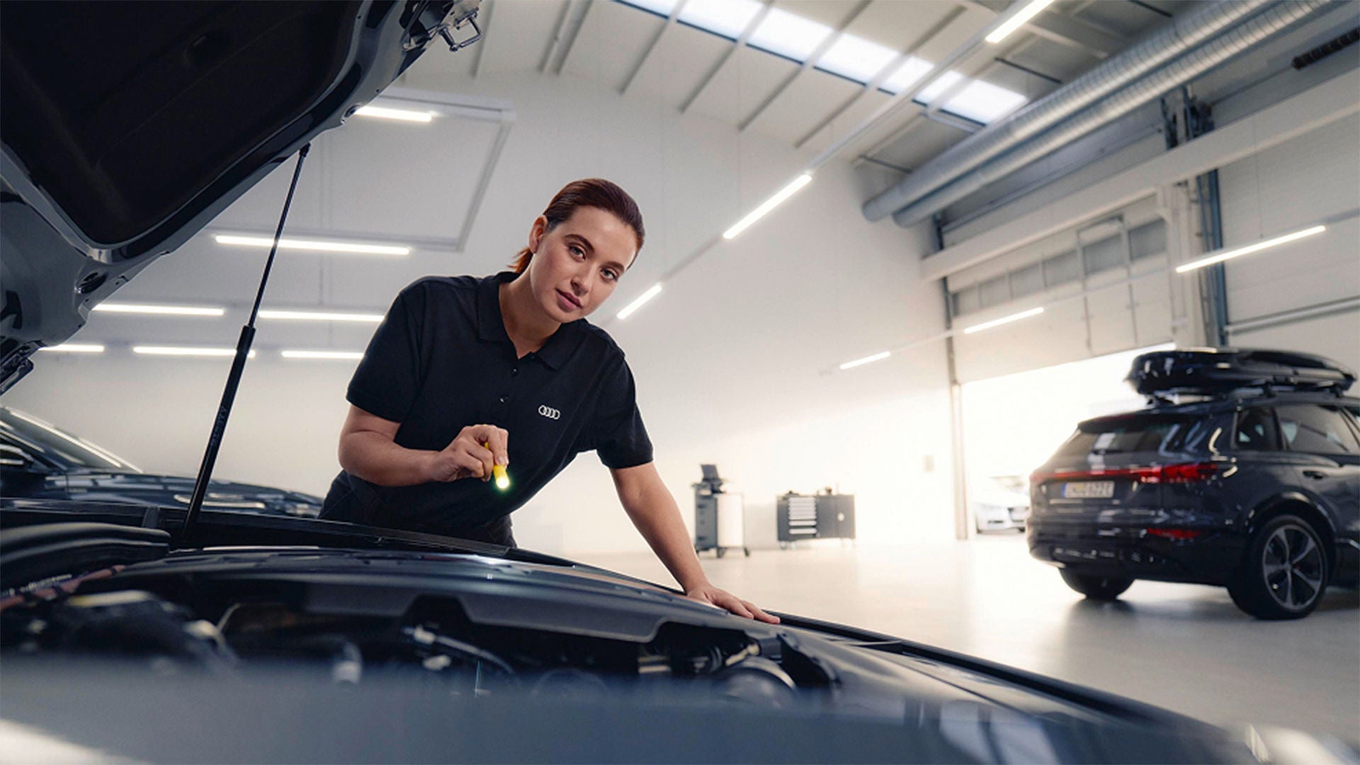 An Audi technician inspects an Audi vehicle.