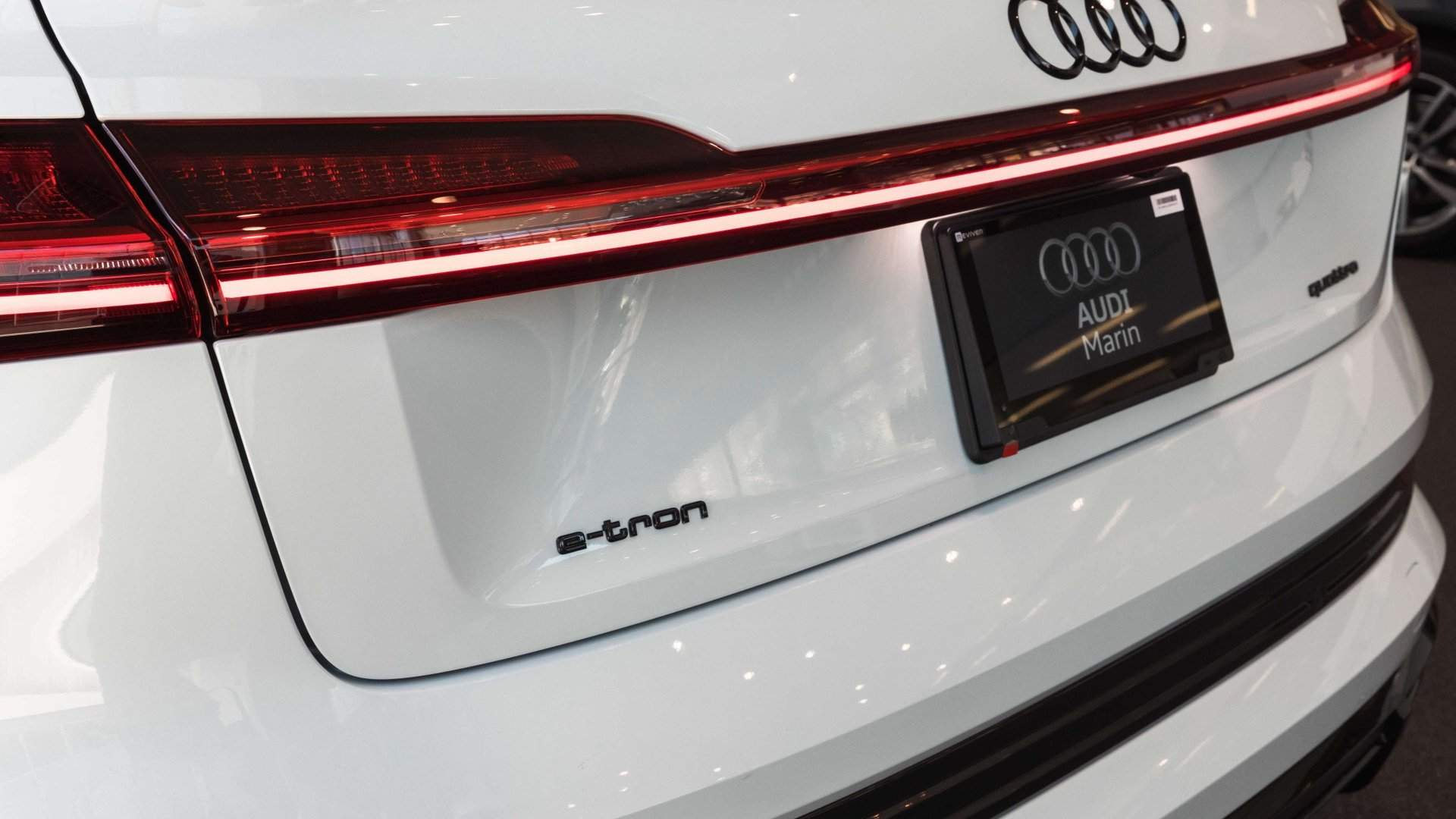 Rear view of an Audi E-tron vehicle parked.