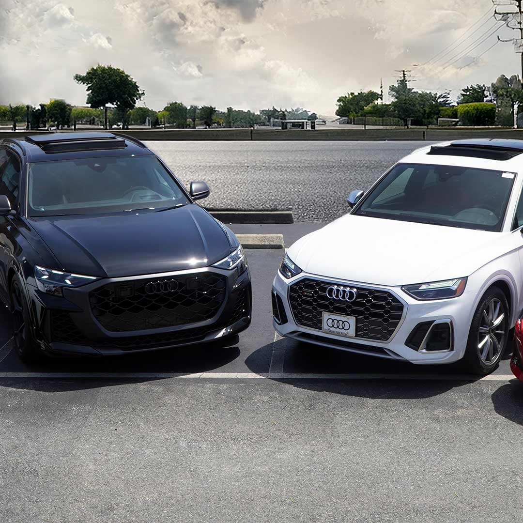 Front view of 2 Audis parked in parking lot