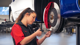 Audi Technician Performing Brake Service.