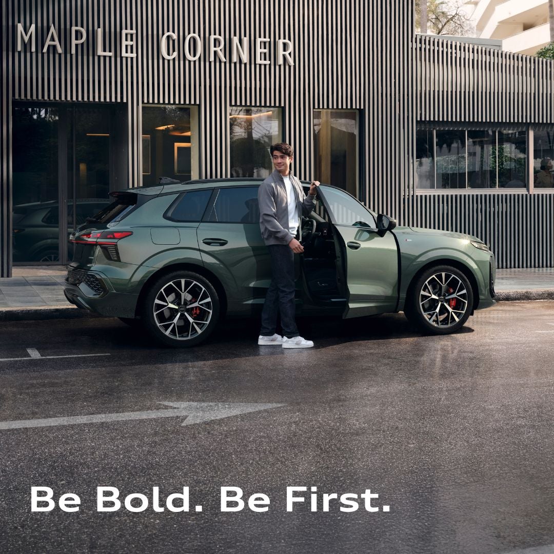 image of a person getting out of the passenger side of a 2026 Audi Q3