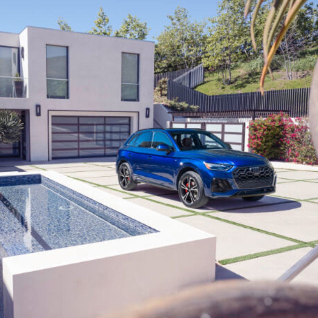 2025 Audi Q5 Exterior Parked In Driveway By House With Waterfall