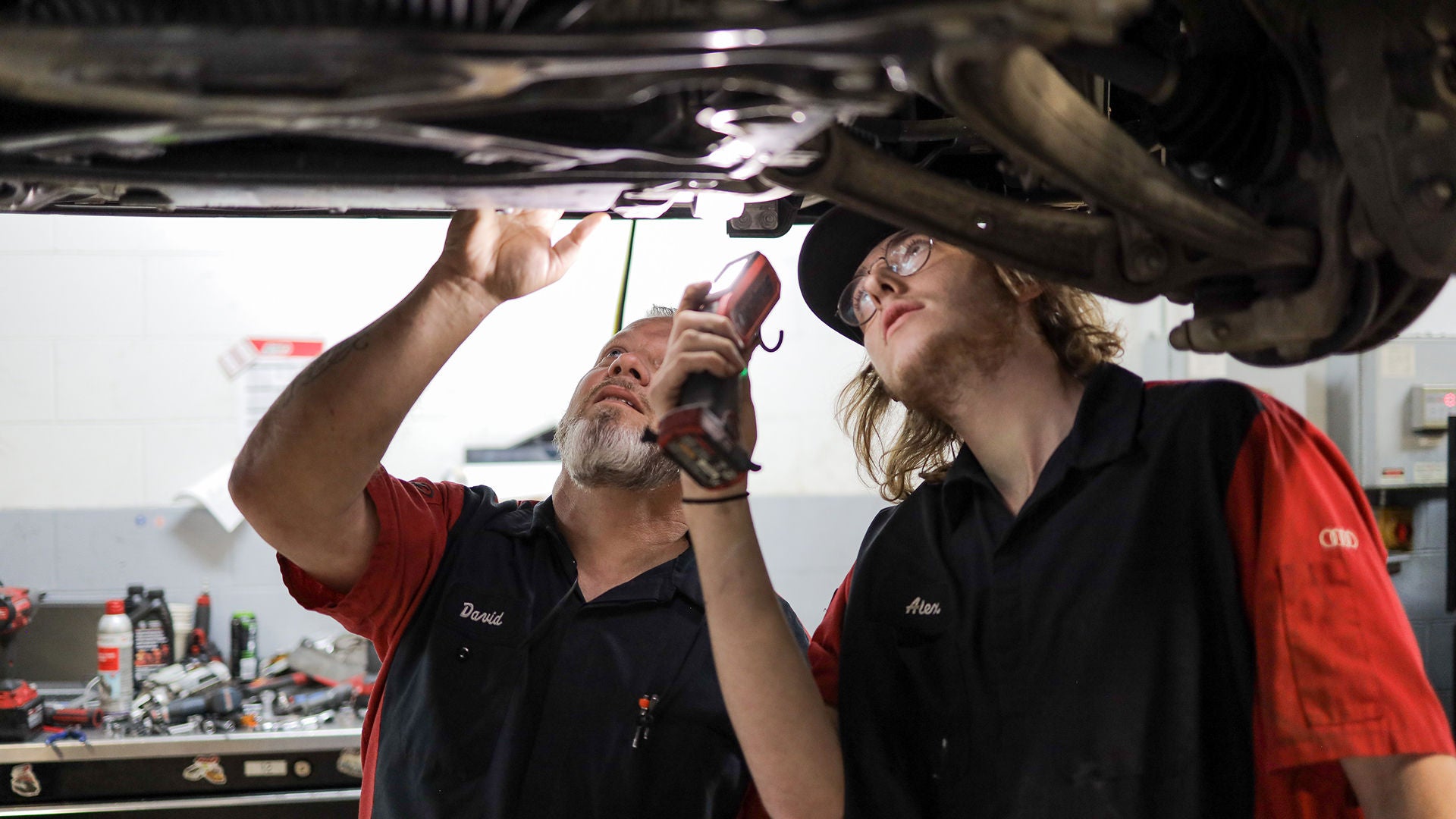 Audi service technician servicing a vehicle.