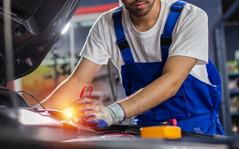 Service technician testing battery