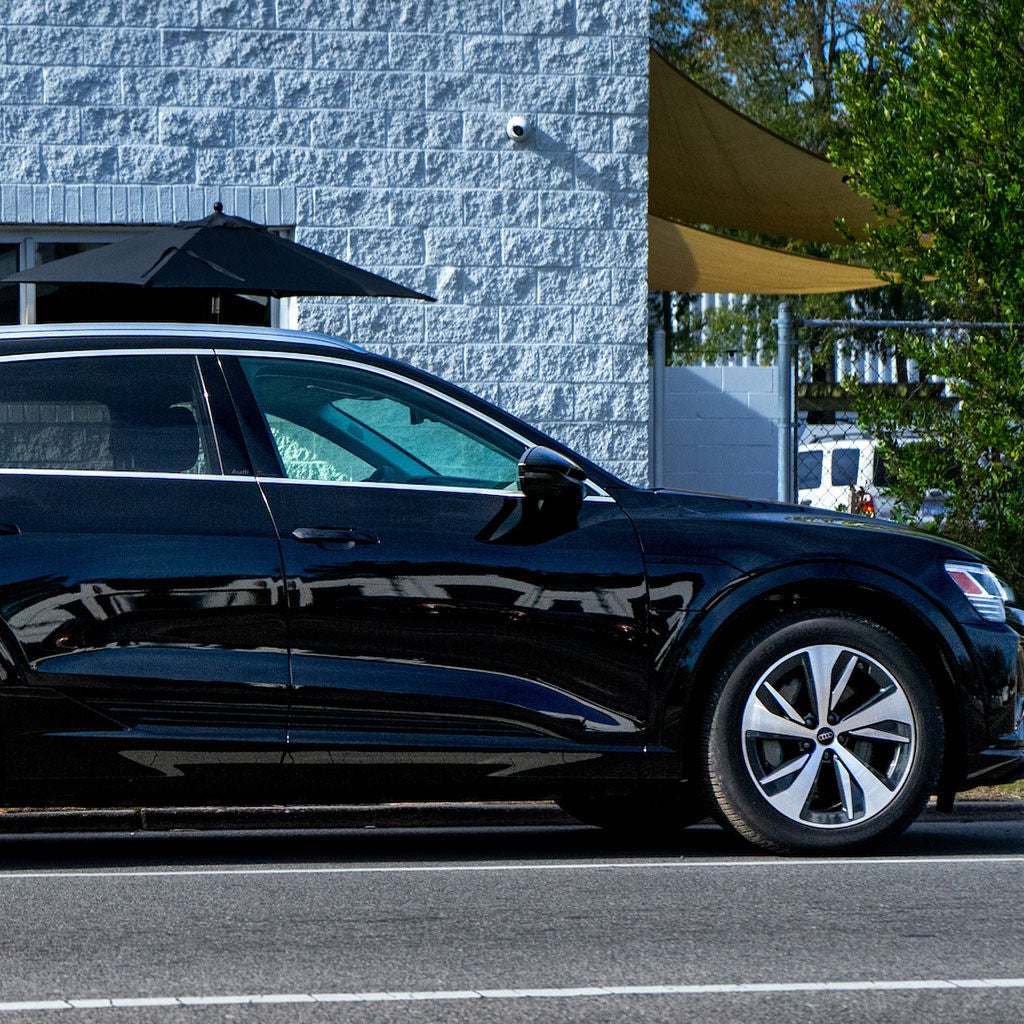 Left profile view of an Audi vehicle parked.
