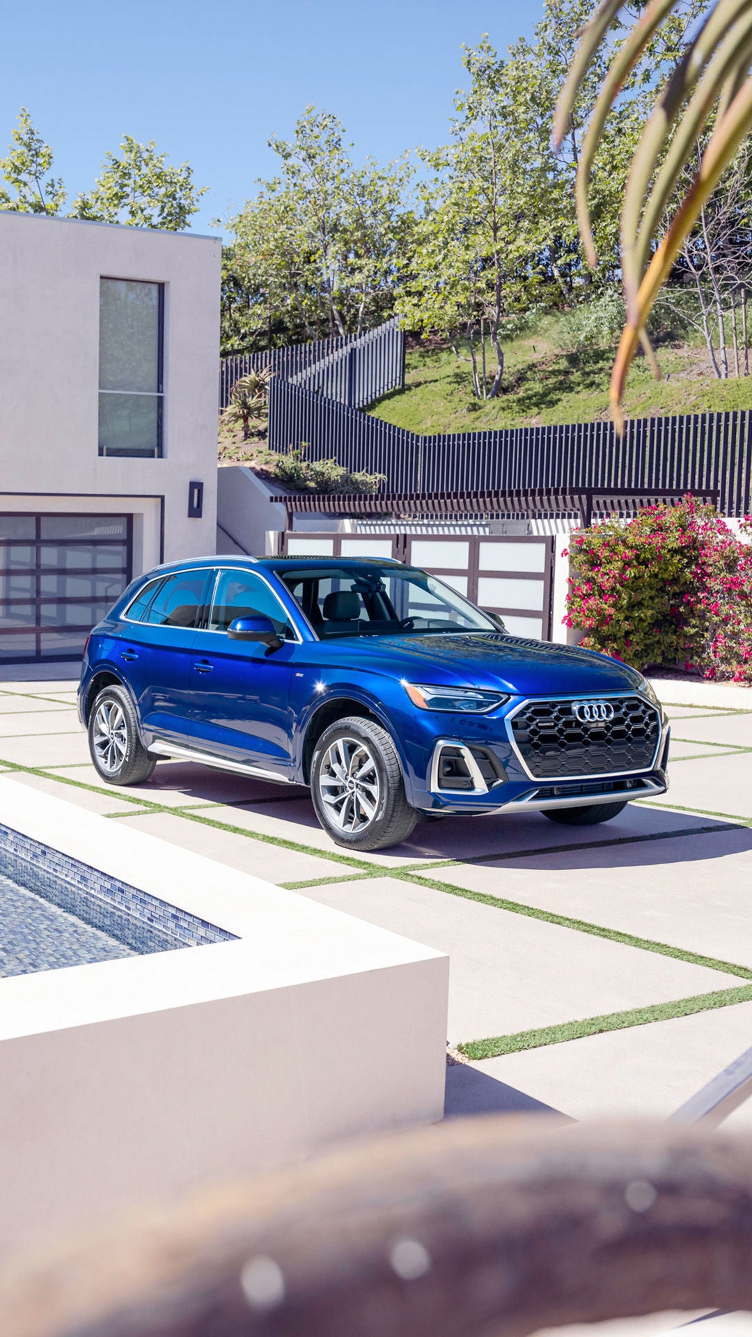 Front 3/4 shot of the 2025 Audi Q5 parked in driveway.