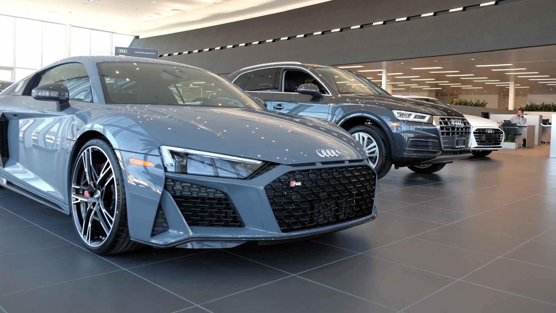 Close-up front view of a line-up of Audi vehicles.