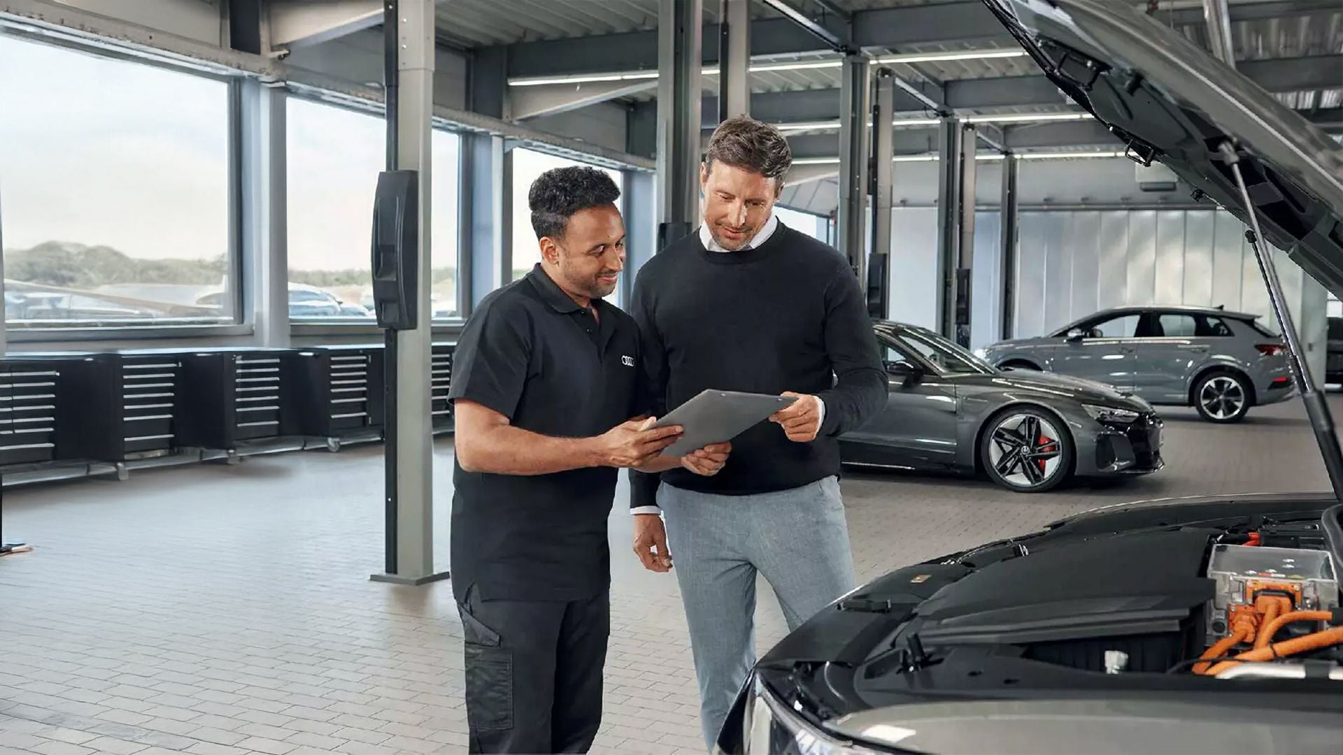 Audi service consultant speaking with a client