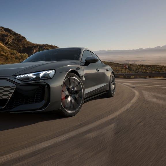 Close-up on the front headlight of the Audi RS e-tron GT in motion.