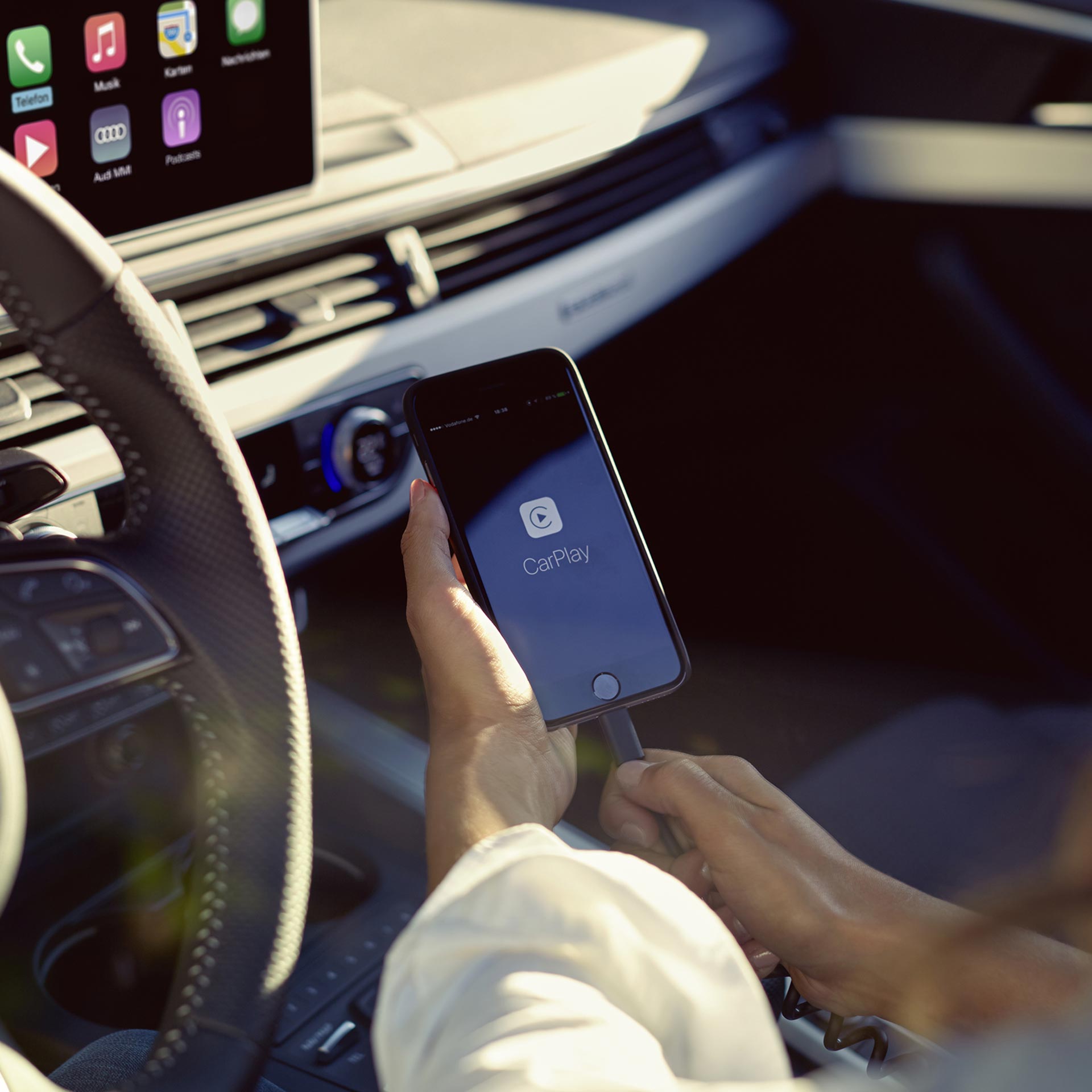 A close-up photo of an Apple iPhone screen displaying the Apple CarPlay smartphone app.