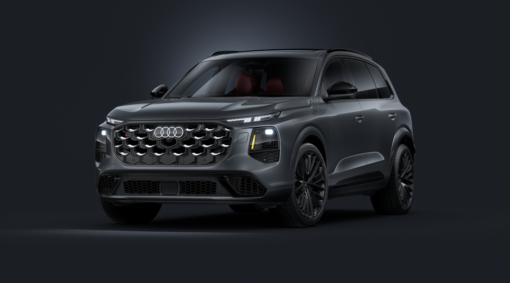 Slanted front view of the Audi SQ7 SUV against a dark background.