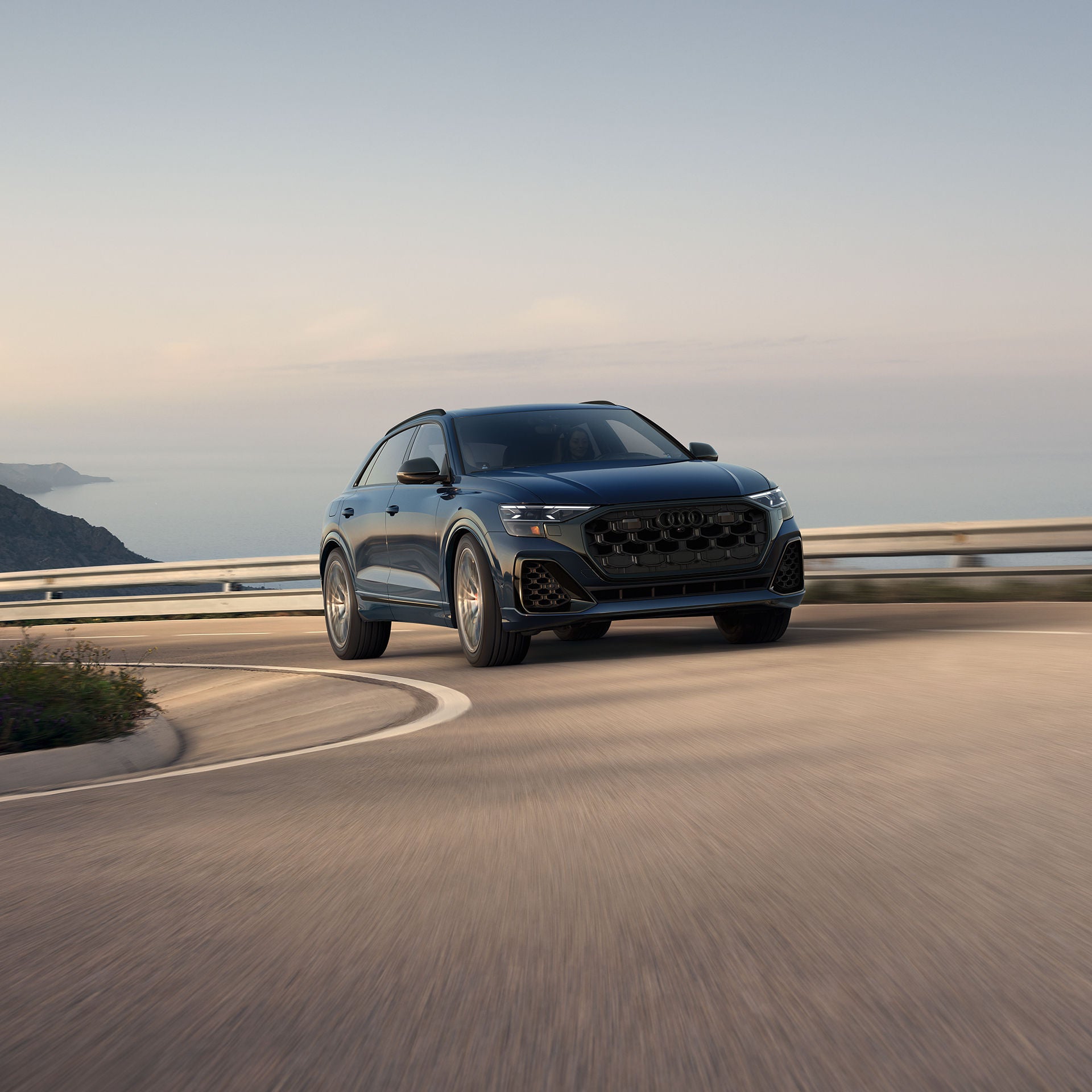 Three-quarter front view of the Audi SQ8 accelerating.