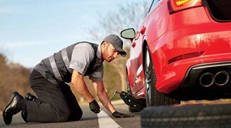 Service technician servicing vehicle.